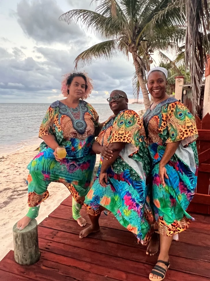 adrienne and two others at the beach in beautiful, colorful and identical outfits